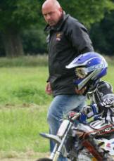 Biker and dad returning to the paddock