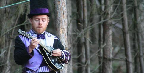 Mandolin playing in a very tall hat