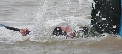 Stunt canoeist enjoying the freezing water