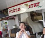 Youthful pizza throwing in Stradbroke