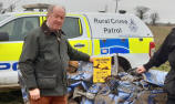 PCC Tim Passmore (left) with a crushed car - pic Suffolk Constabulary